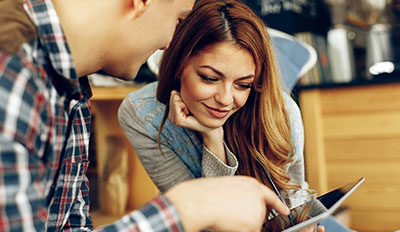 A couple using tablet to view helpful tips.