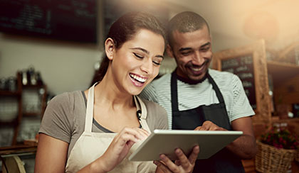 Business owners looking at a tablet device.